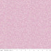 A close-up of a light violet fabric with a repeating small floral and leaf pattern in a slightly darker violet. A ruler along the bottom edge shows measurements in inches and includes the text 'Riley Blake Designs'.