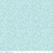 A close-up of a fabric pattern featuring a light aqua background with a dense, repeating white floral and leaf motif. A white ruler along the bottom edge displays the brand 'Riley Blake Designs' and shows the pattern repeats in scale.