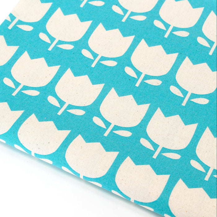 Fabric with white tulip pattern on a turquoise background