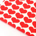 red hearts on unbleached fabric in close up