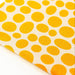 Close-up of yellow polka dot fabric 
