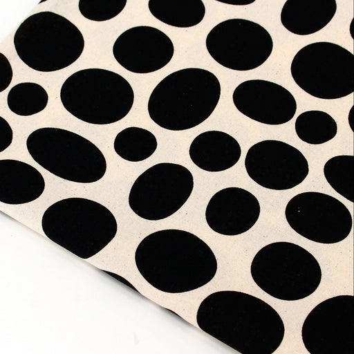 Sheet of black oval stickers on a beige background