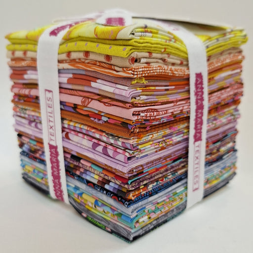 Stack of colorful fabric bundles tied with a band, branded 'Anna Maria' on a light background