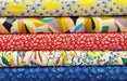 Stack of colorful fabric swatches with various patterns