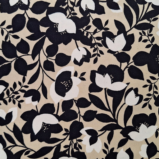 Floral pattern with black and white flowers on a beige background