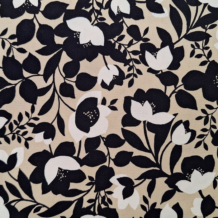 Floral pattern with black and white flowers on a beige background