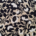 Floral pattern with black and white flowers on a beige background