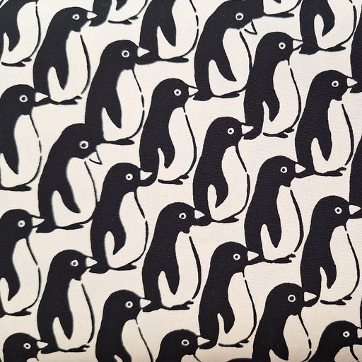 Pattern of black penguins on a beige background