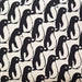 Pattern of black penguins on a beige background