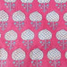 Patterned fabric with white floral design on a pink background
