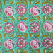 Patterned fabric with pink flowers and green leaves on a teal background