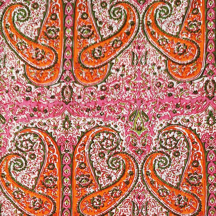 Patterned fabric with orange and green paisley design on a pink background
