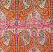 Patterned fabric with orange and green paisley design on a pink background