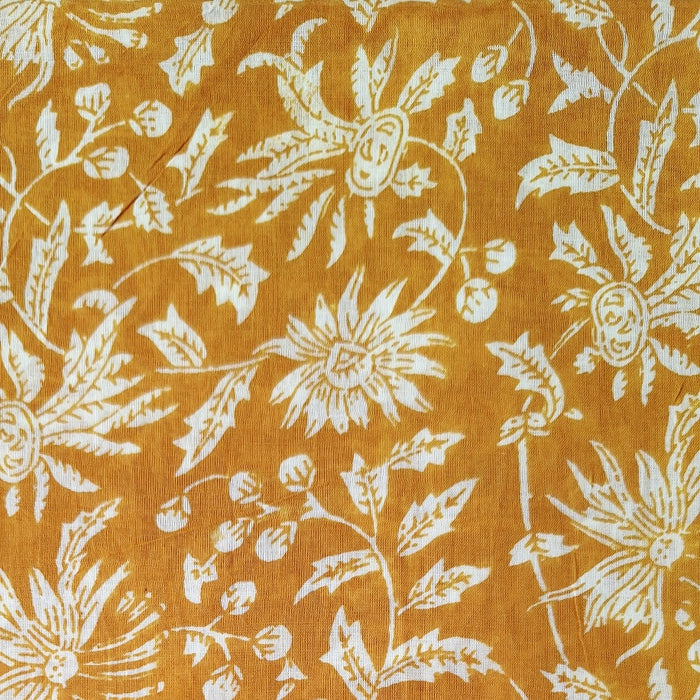 Floral pattern on fabric with white flowers on a mustard yellow background