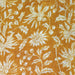 Floral pattern on fabric with white flowers on a mustard yellow background
