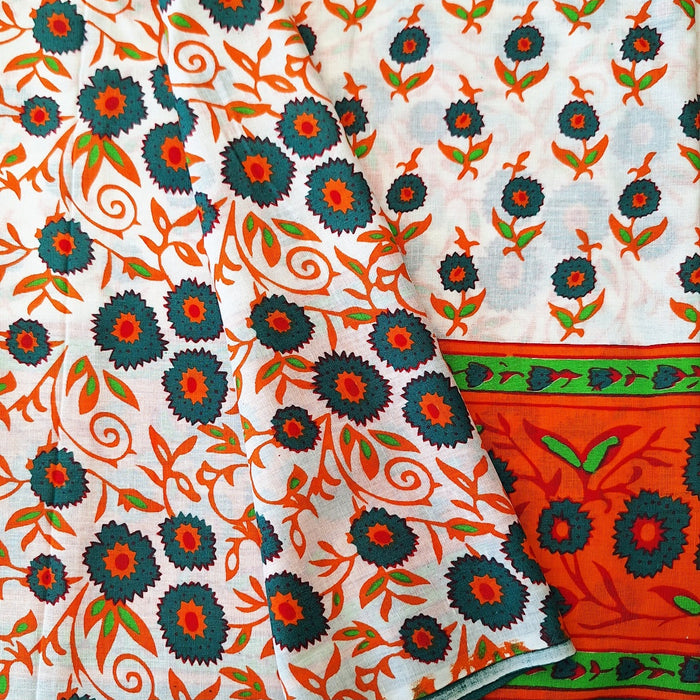 Decorative fabric with floral patterns in orange, green, and black on a white background.