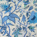 Blue floral and bird pattern on a beige background