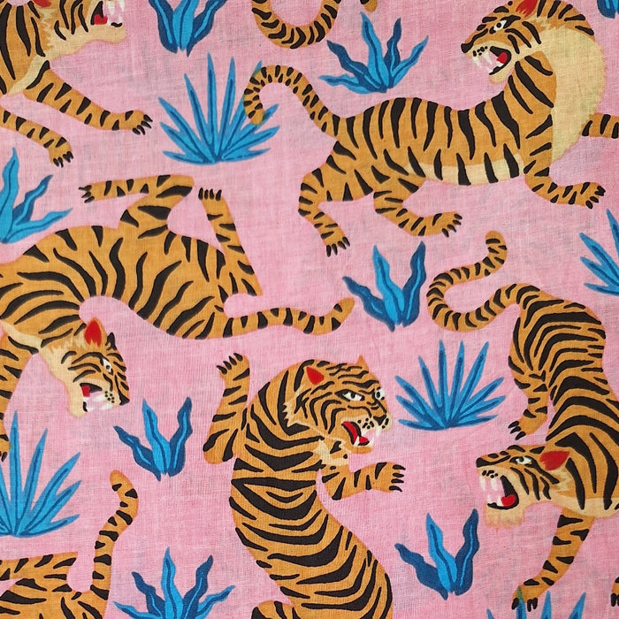 Pattern of tigers and blue plants on a pink background