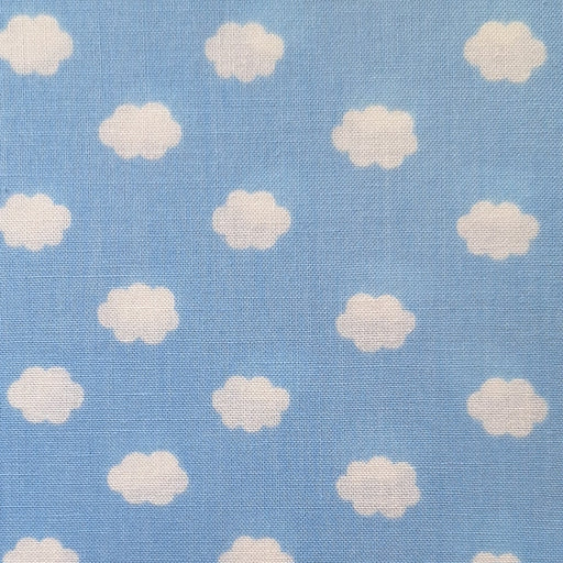 Light blue fabric with a repeating pattern of small white clouds, showing a visible woven texture.