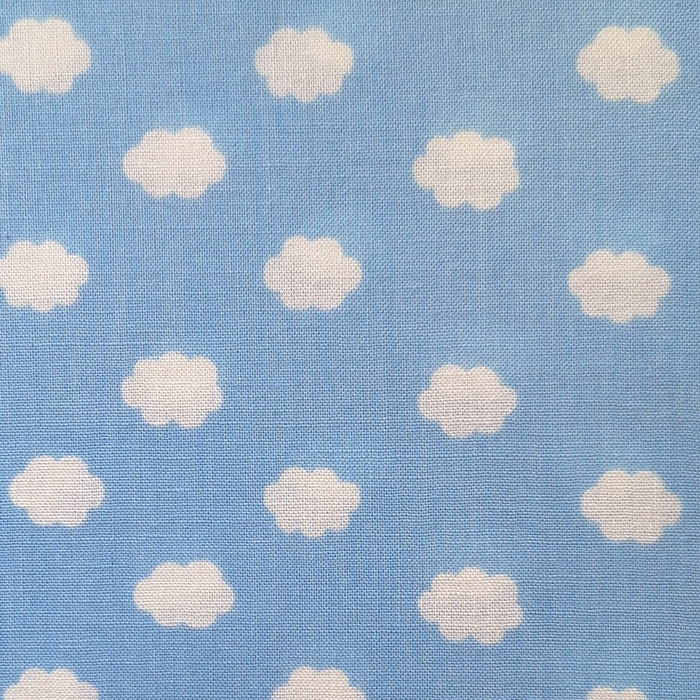 Light blue fabric with a repeating pattern of small white clouds, showing a visible woven texture.