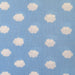 Light blue fabric with a repeating pattern of small white clouds, showing a visible woven texture.