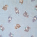 Light blue fabric with a repeating pattern of cute cartoon koalas in muted gray, brown, and white tones.