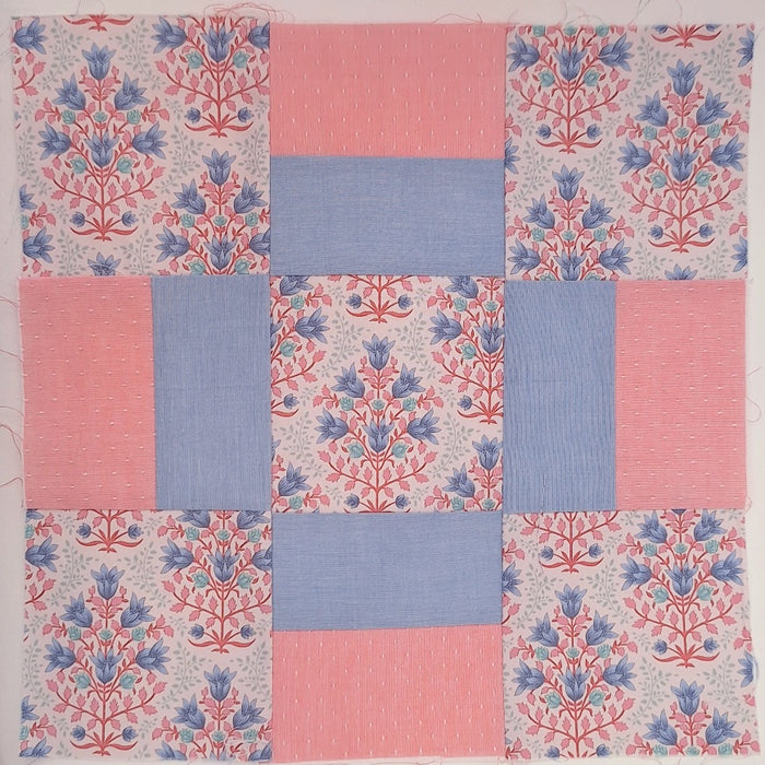 quilt block made up of pink and blue fabrics