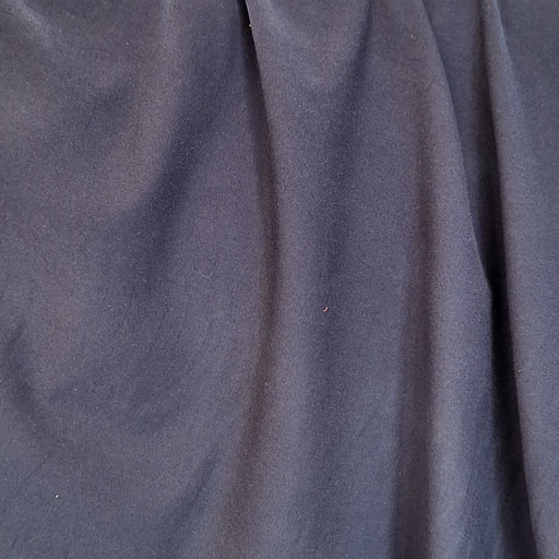 close up of navy jersey fabric draped 
