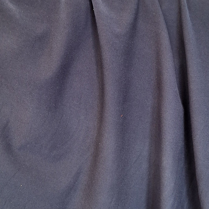 close up of navy jersey fabric draped 
