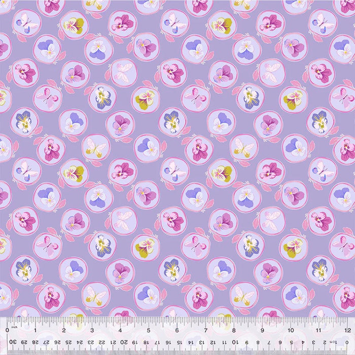 Floral patterned fabric with a ruler at the bottom for scale on a purple background