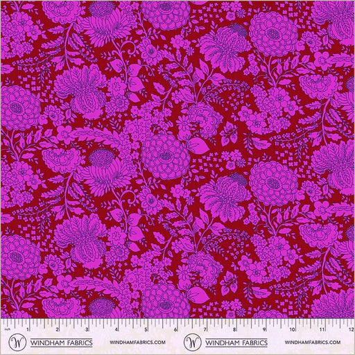 Floral fabric pattern with pink flowers on a red background, featuring a ruler at the bottom.