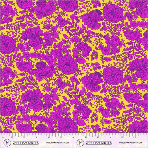 Floral pattern fabric with purple flowers on a yellow background, featuring a ruler at the bottom.