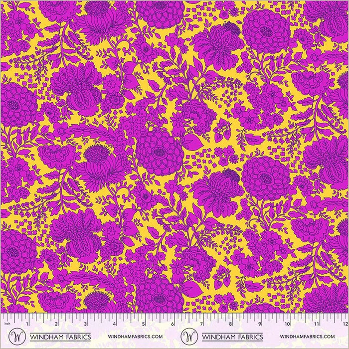 Floral pattern fabric with purple flowers on a yellow background, featuring a ruler at the bottom.