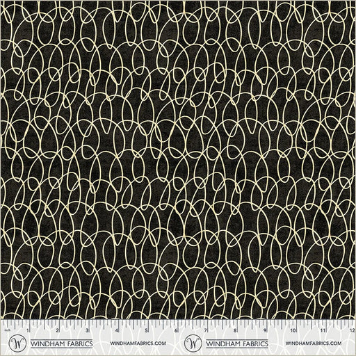 Fabric with a geometric pattern on a black background, featuring Windham Fabrics branding.