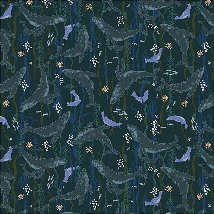 fabric closeup of whales and seals on dark teal background swimming amongst sea plants
