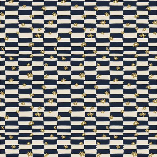 close up of fabric with an irregular checkboard of navy and cream and small gold daisy shapes scattered on top
