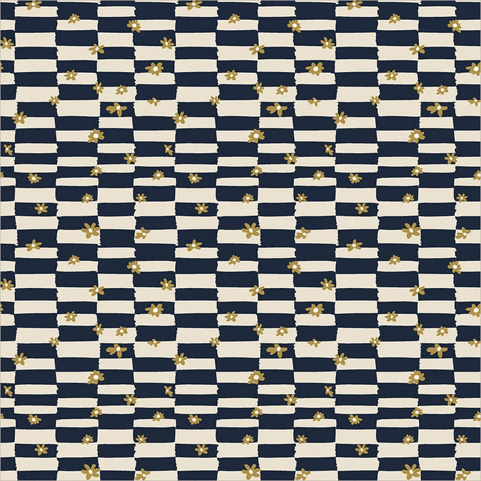 close up of fabric with an irregular checkboard of navy and cream and small gold daisy shapes scattered on top