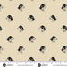 Pattern of black and white dogs on beige fabric with a ruler for scale.