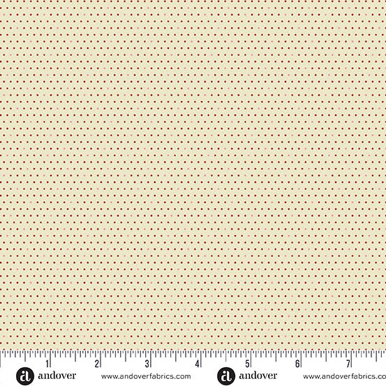 Micro dots of deep red on beige fabric with a ruler at the bottom for scale.