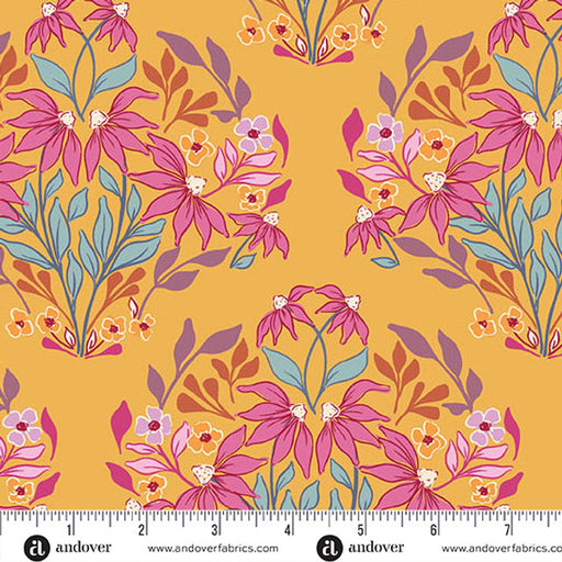 A repeating fabric pattern featuring pink flowers, light blue leaves, and small orange floral accents on a mustard yellow background, with a white ruler along the bottom showing measurements and the andover Fabrics logo.