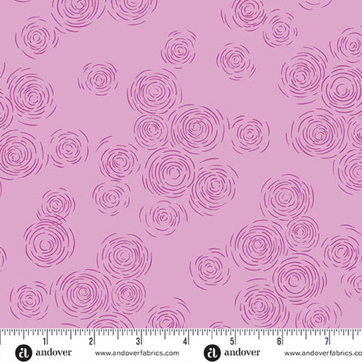 A purple  fabric pattern featuring purple spiral and swirl motifs, with a white ruler and Andover fabric branding along the bottom edge.