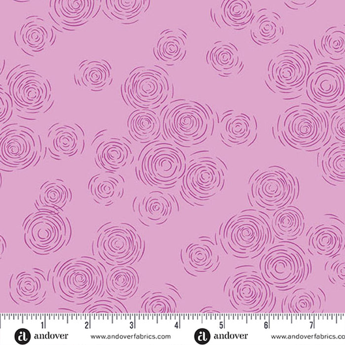 A purple  fabric pattern featuring purple spiral and swirl motifs, with a white ruler and Andover fabric branding along the bottom edge.