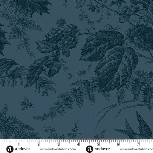 Green fabric with nature-themed pattern featuring leaves, berries, and a bee, with a ruler at the bottom for scale.