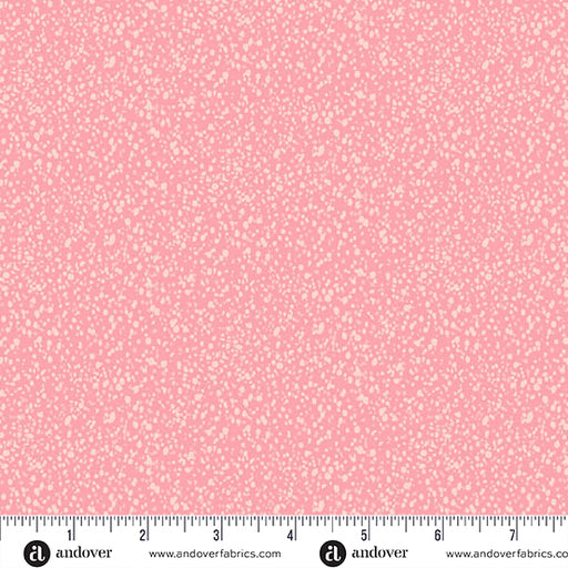 Pink fabric with a small white pattern and a ruler at the bottom for scale.