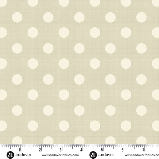 Fabric with white polka dots on a beige background, featuring Andover Fabrics branding.