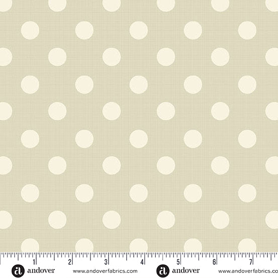 Fabric with white polka dots on a beige background, featuring Andover Fabrics branding.