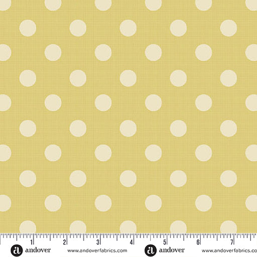 Fabric with white polka dots on a yellow background, featuring Andover Fabrics branding.
