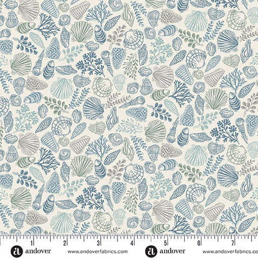 Seashell pattern fabric with a ruler at the bottom for scale, featuring blue and green designs on a beige background.