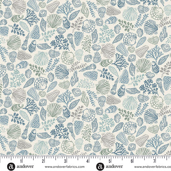 Seashell pattern fabric with a ruler at the bottom for scale, featuring blue and green designs on a beige background.