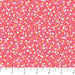 Pink floral fabric pattern with a ruler at the bottom